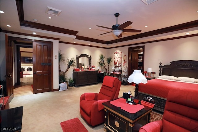 bedroom with separate washer and dryer, ceiling fan, crown molding, light carpet, and a raised ceiling