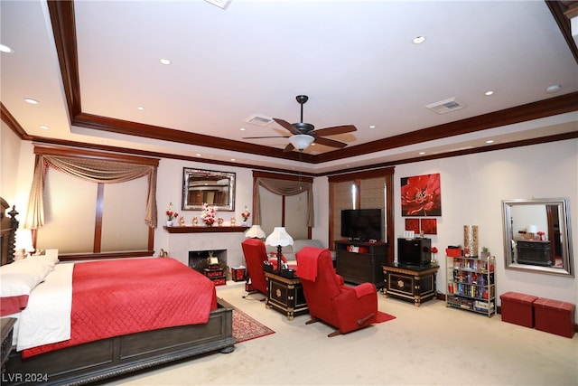 bedroom featuring light carpet, a raised ceiling, ceiling fan, and crown molding