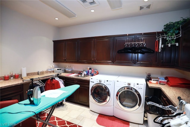 laundry room with sink, washing machine and dryer, and light tile flooring