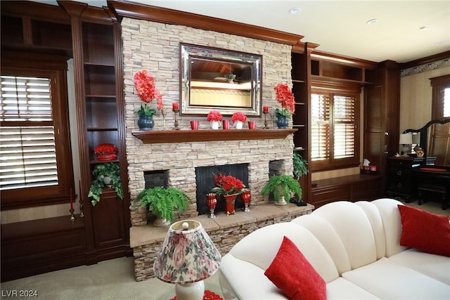 living room with light colored carpet, built in features, and a fireplace