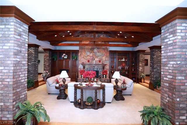 living room featuring light colored carpet, decorative columns, and beam ceiling