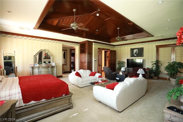 carpeted bedroom with a tray ceiling, wooden ceiling, and ceiling fan