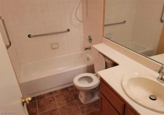 full bathroom featuring large vanity, toilet, tiled shower / bath, and tile flooring