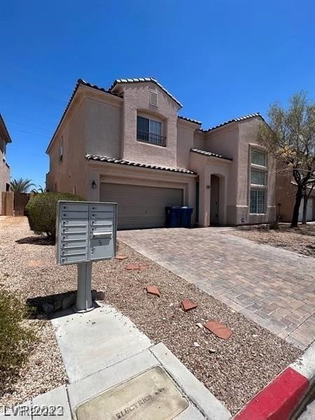 mediterranean / spanish-style home with a garage