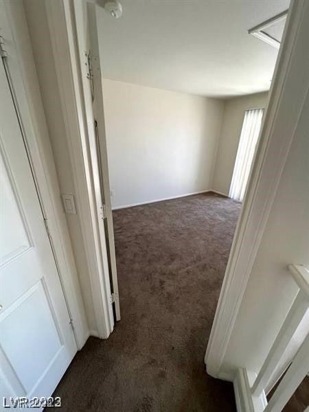 hallway with dark carpet