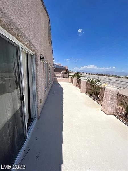 view of patio featuring a balcony