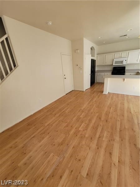 unfurnished living room with light wood-type flooring