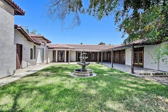 exterior space featuring french doors, a lawn, and a patio