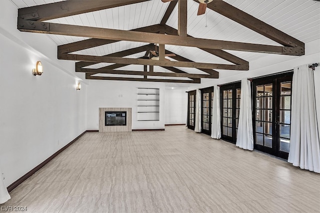 unfurnished living room featuring a tiled fireplace, beamed ceiling, and light tile floors