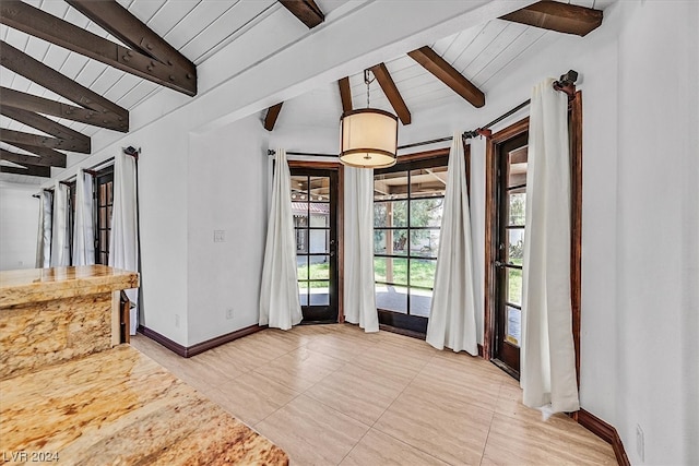 interior space featuring vaulted ceiling with beams and light tile flooring