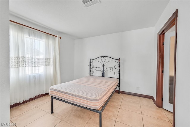 bedroom featuring light tile floors