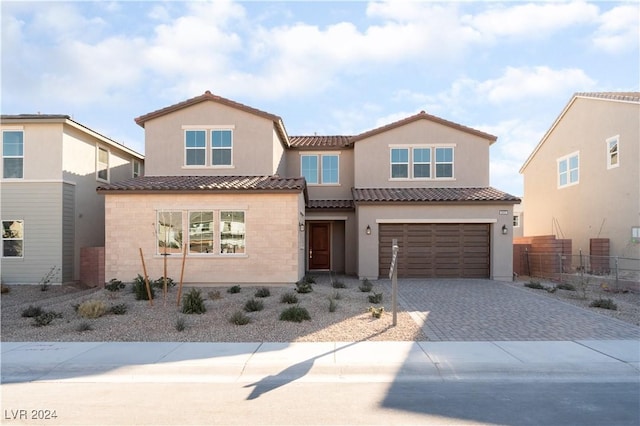 mediterranean / spanish house featuring a garage