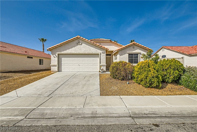 5717 Wizard Wand St, North Las Vegas, NV 89031 - mediterranean / spanish-style house with a tile roof, stucco siding, a garage, and concrete driveway