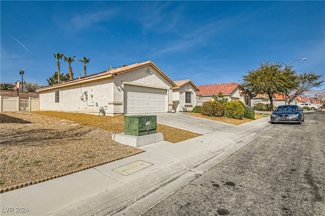 5717 Wizard Wand St, North Las Vegas, NV 89031 - view of front of house with stucco siding, an attached garage, and concrete driveway