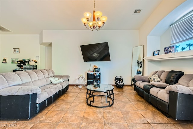 tiled living room featuring a chandelier