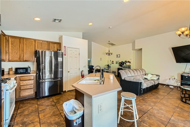 5717 Wizard Wand St, North Las Vegas, NV 89031 - kitchen featuring freestanding refrigerator, a sink, lofted ceiling, white gas range oven, and open floor plan