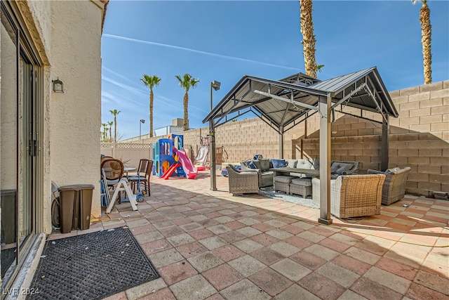 view of patio featuring a playground and an outdoor hangout area