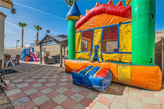 5717 Wizard Wand St, North Las Vegas, NV 89031 - fenced backyard with a gazebo, an outdoor living space, and a patio