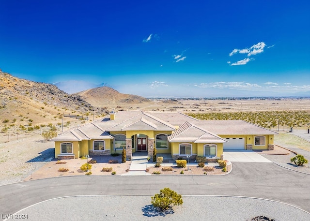 view of front of house featuring a mountain view and a garage