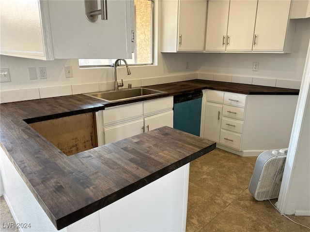 kitchen with sink, stainless steel dishwasher, and white cabinetry