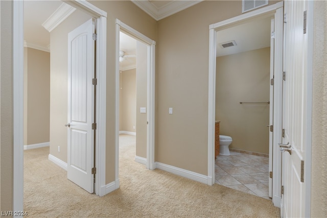 hallway featuring ornamental molding and light colored carpet