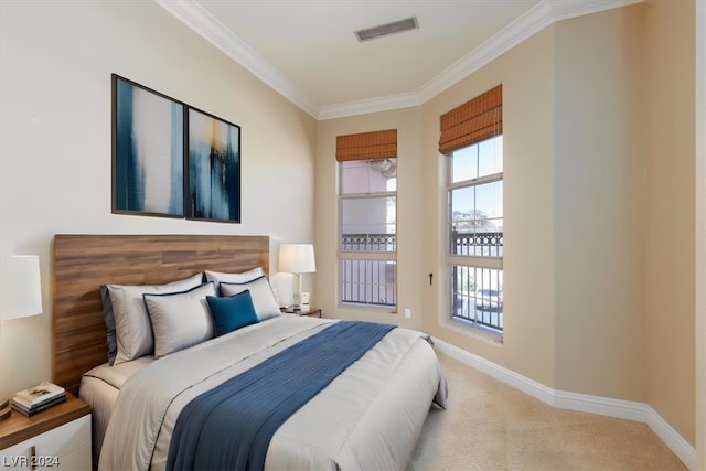 carpeted bedroom featuring multiple windows and ornamental molding