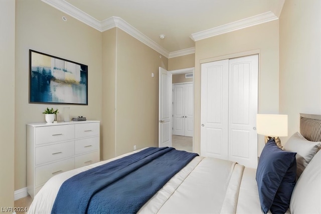 carpeted bedroom featuring ornamental molding and a closet