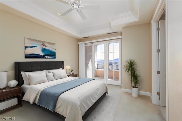 bedroom featuring ceiling fan, ornamental molding, a tray ceiling, and access to outside