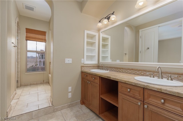 bathroom featuring double sink vanity and tile flooring