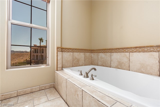 bathroom featuring tile floors and tiled tub