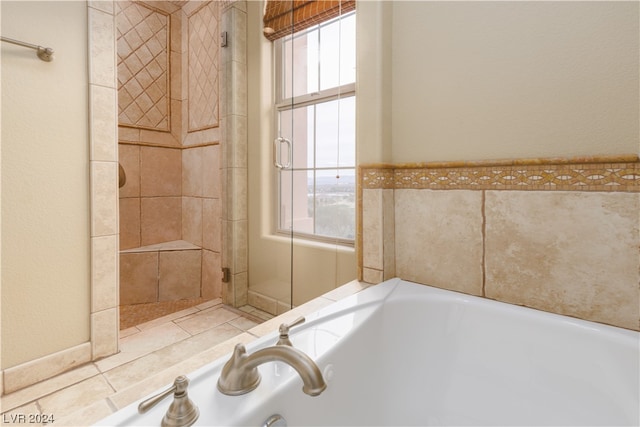 bathroom featuring shower with separate bathtub