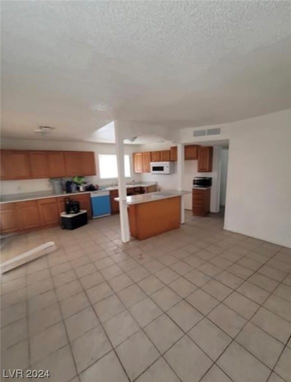 kitchen with light tile flooring and a kitchen island