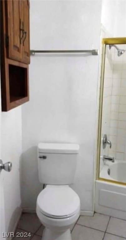 bathroom featuring shower / tub combination, toilet, and tile floors