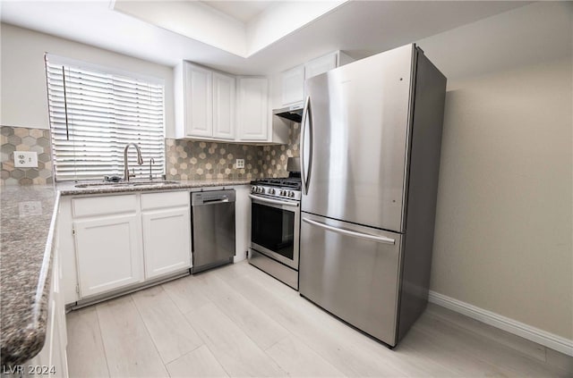 kitchen featuring white cabinets, backsplash, sink, and stainless steel appliances