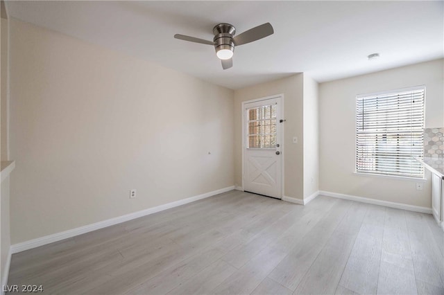 spare room with ceiling fan and light hardwood / wood-style flooring