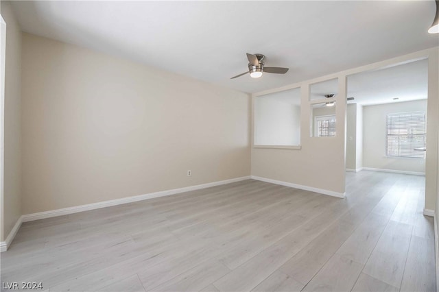 unfurnished room with ceiling fan and light wood-type flooring