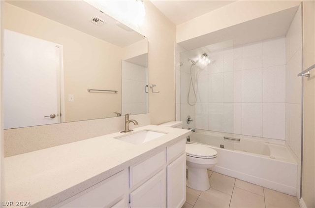 full bathroom featuring tiled shower / bath combo, toilet, vanity, and tile flooring