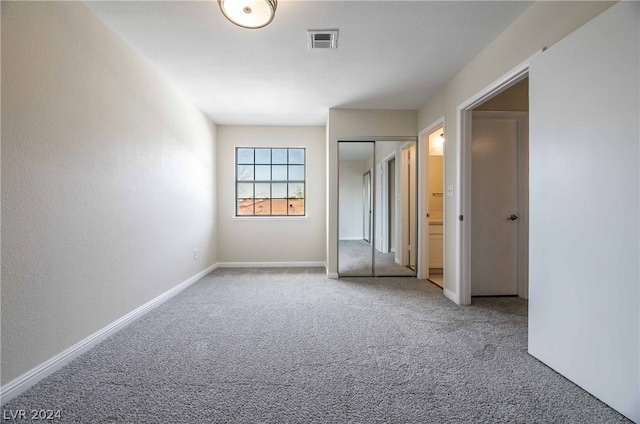 unfurnished bedroom featuring light carpet