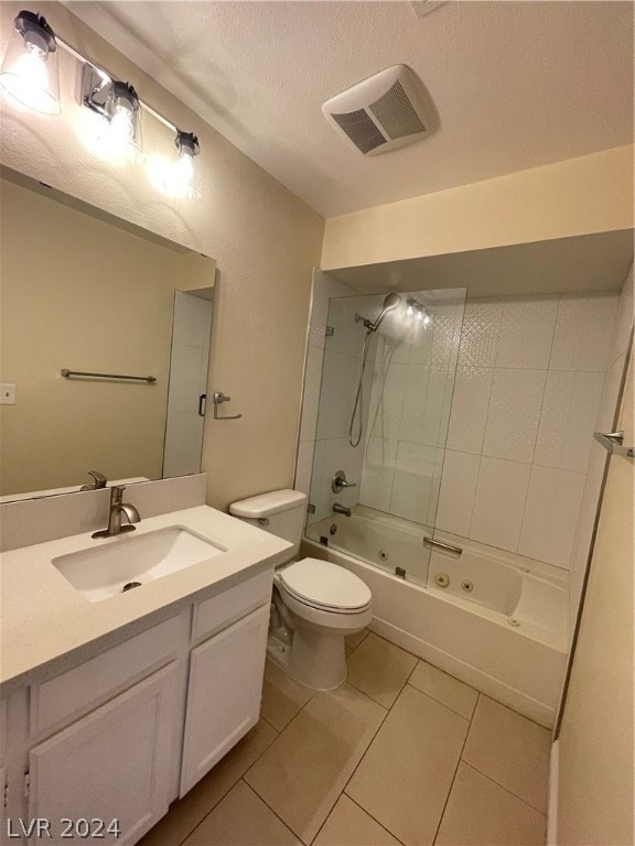 full bathroom with toilet, tiled shower / bath, a textured ceiling, large vanity, and tile floors