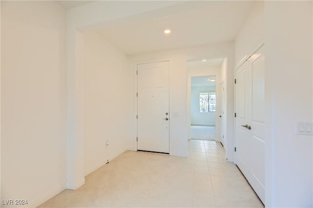 hall with light tile patterned floors