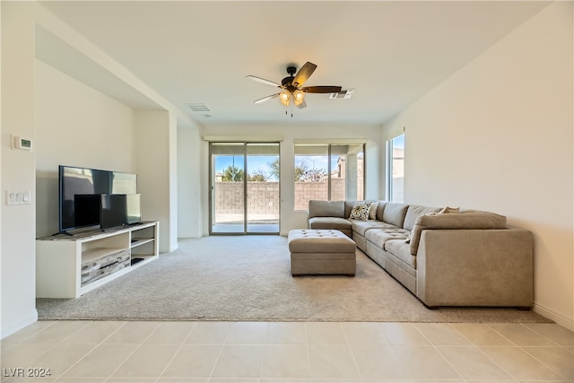 living room with ceiling fan and light tile patterned flooring