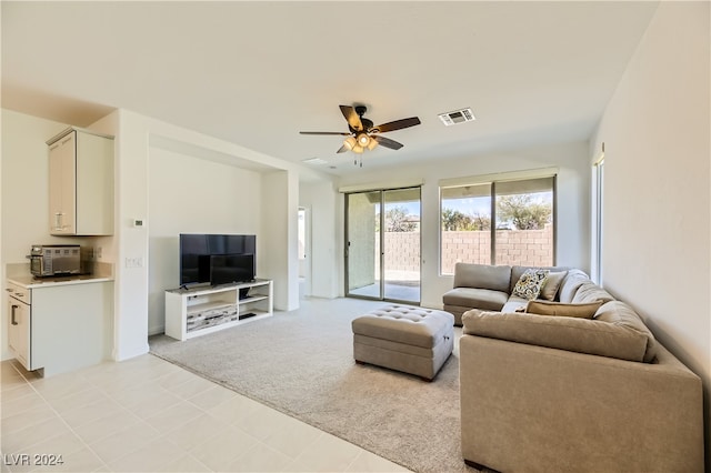 living room with light carpet and ceiling fan