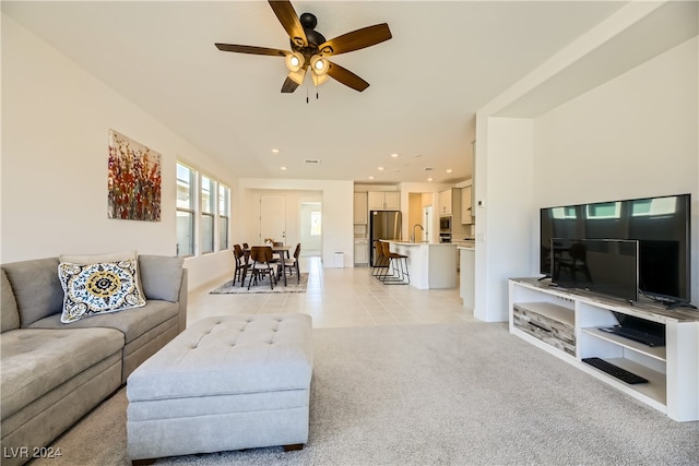 tiled living room featuring ceiling fan and sink