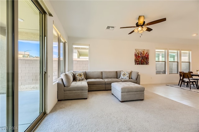 living room with ceiling fan and light carpet