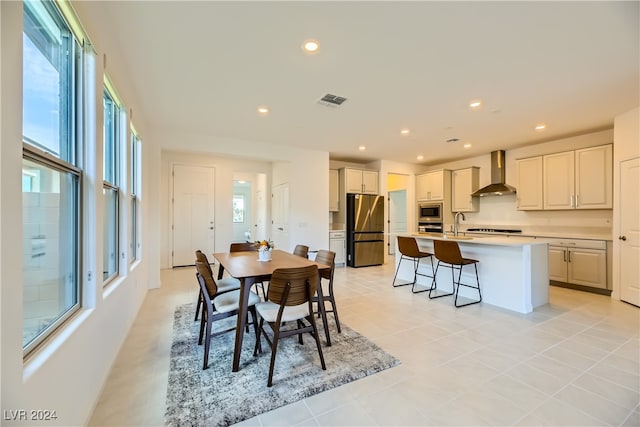 dining area featuring sink and light tile patterned floors