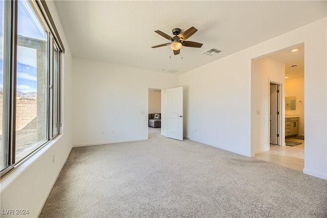 empty room with ceiling fan and light colored carpet