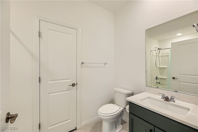 bathroom featuring tile patterned floors, vanity, and toilet