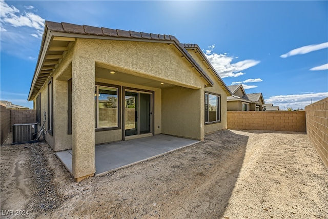 rear view of house featuring central air condition unit and a patio