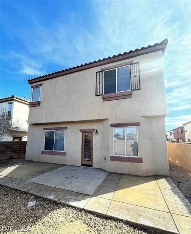 back of house with a patio