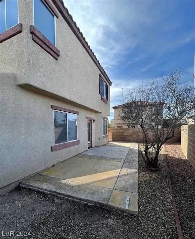 view of property exterior with a patio